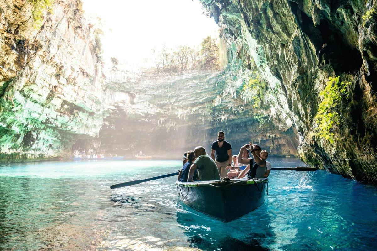 a group of people in a boat in a cave