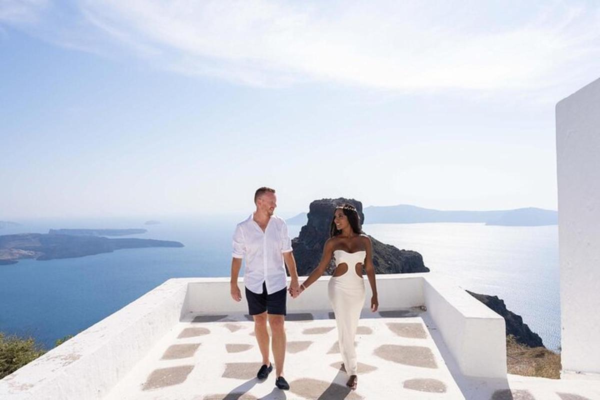 a man and a woman holding hands while standing on a ledge