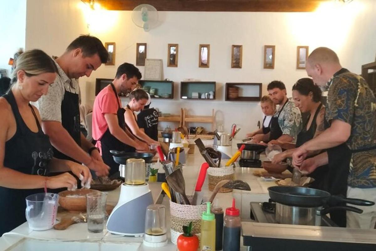 a group of people standing around a counter preparing food