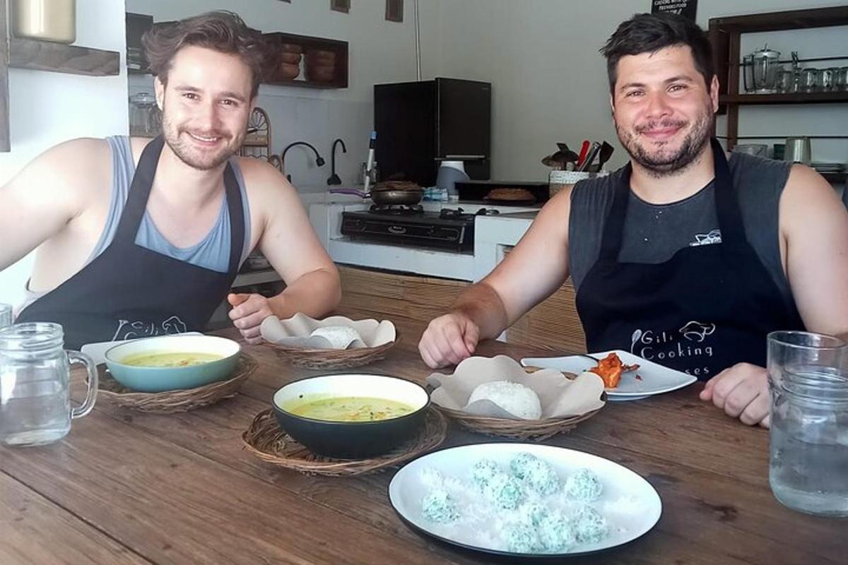 two men sitting at a table with bowls of food
