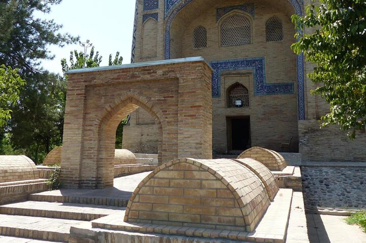 a building with an arch in front of a building