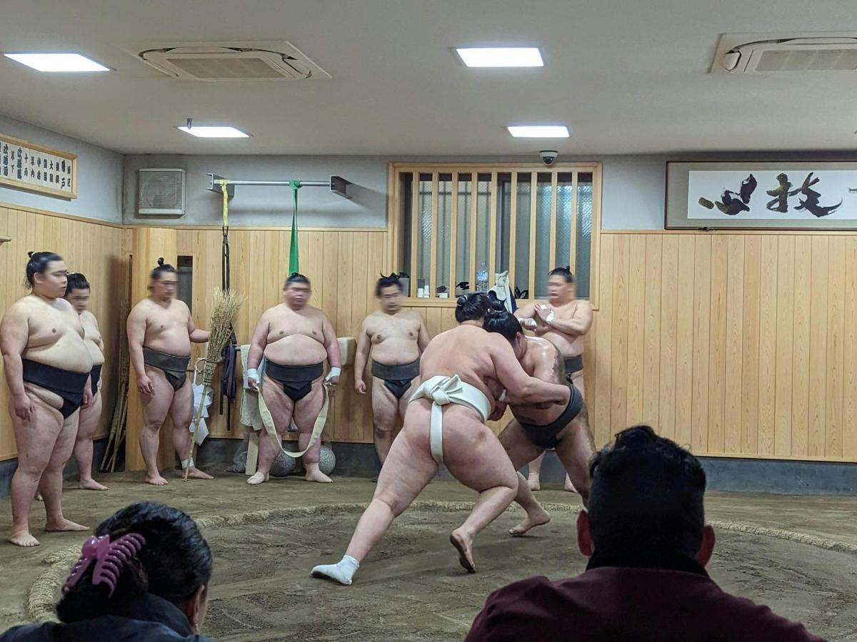 a group of men in underwear standing in a room