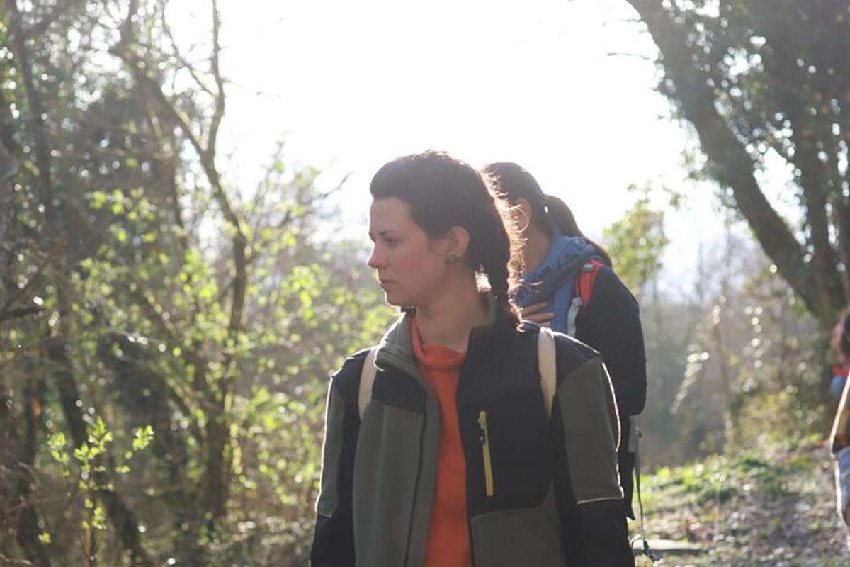 uma mulher caminhando em uma trilha na floresta