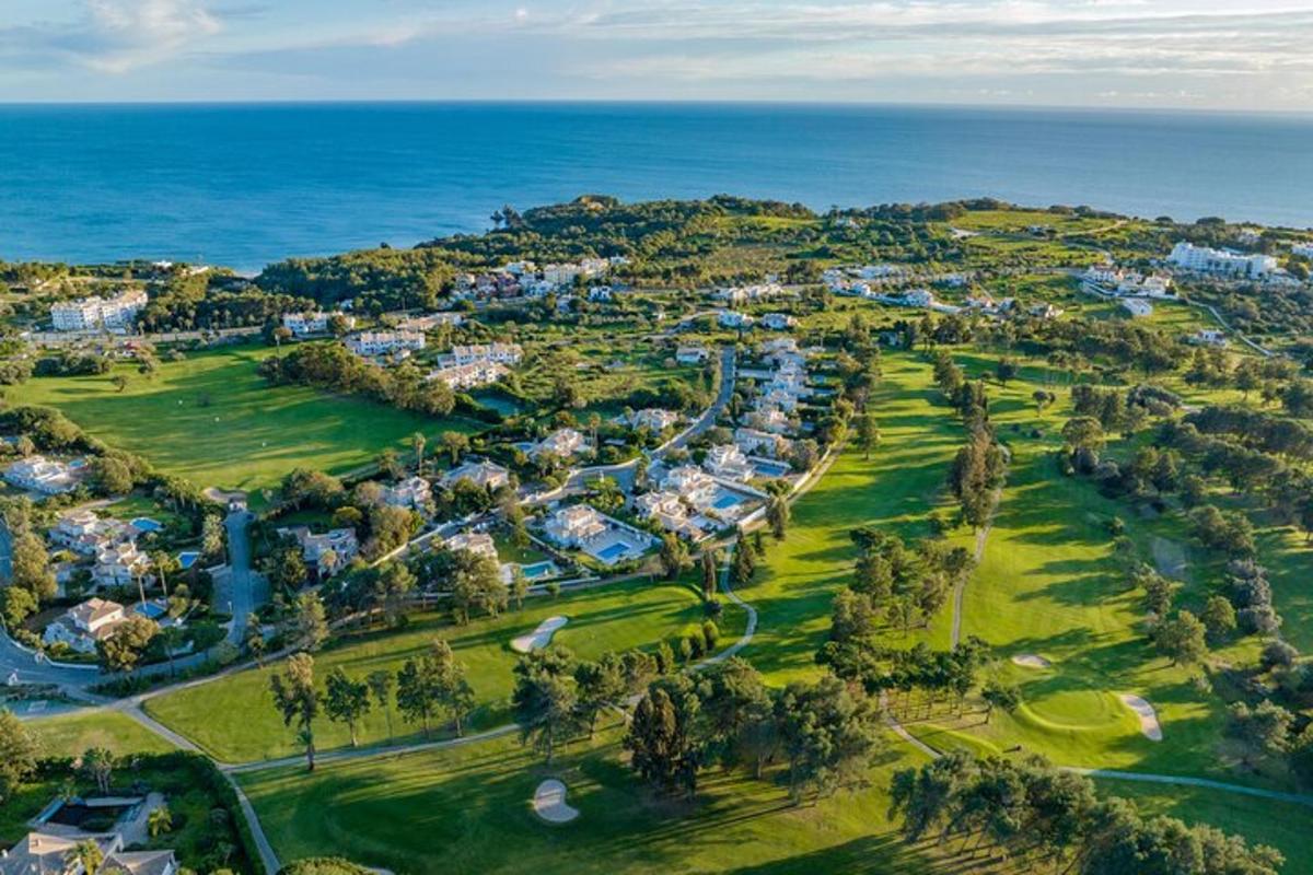 an aerial view of a golf course next to the ocean