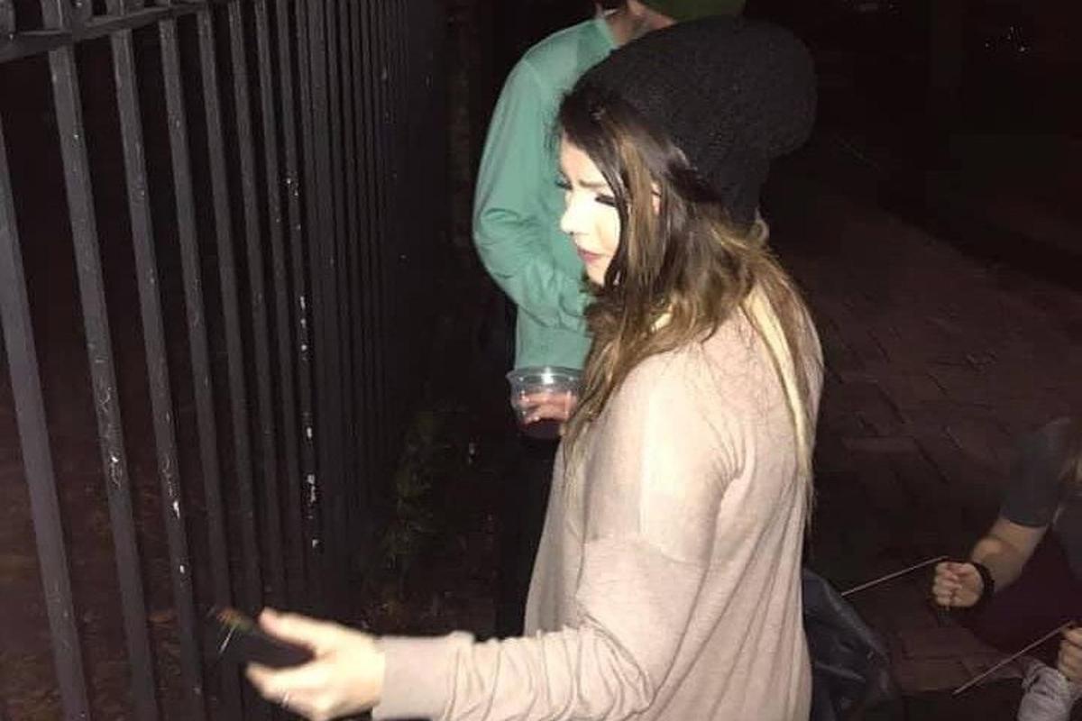 a woman is looking at her cell phone