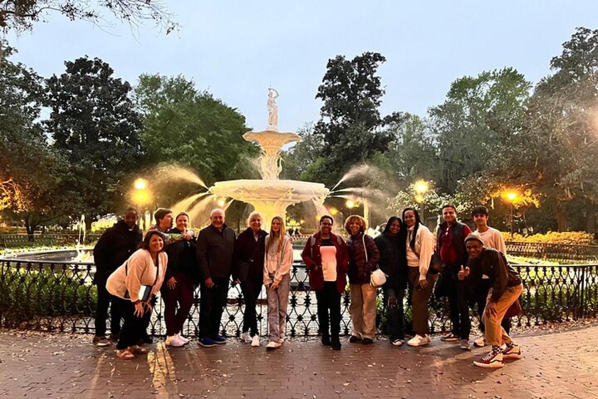 a group of people standing in front of a fountain