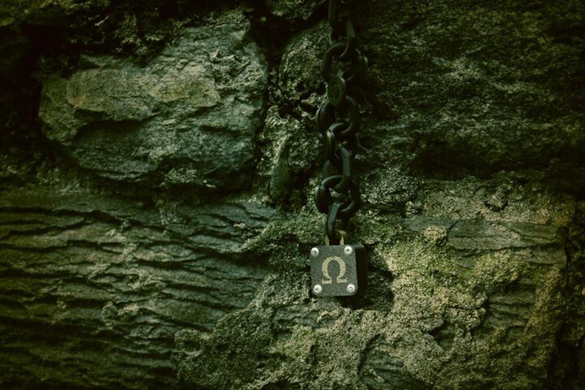 a chain attached to a stone wall with a number on it