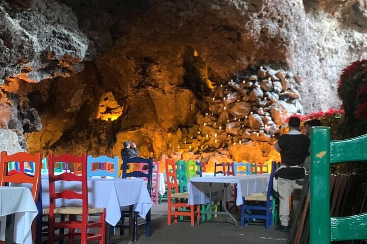 a dining room in a cave with tables and chairs