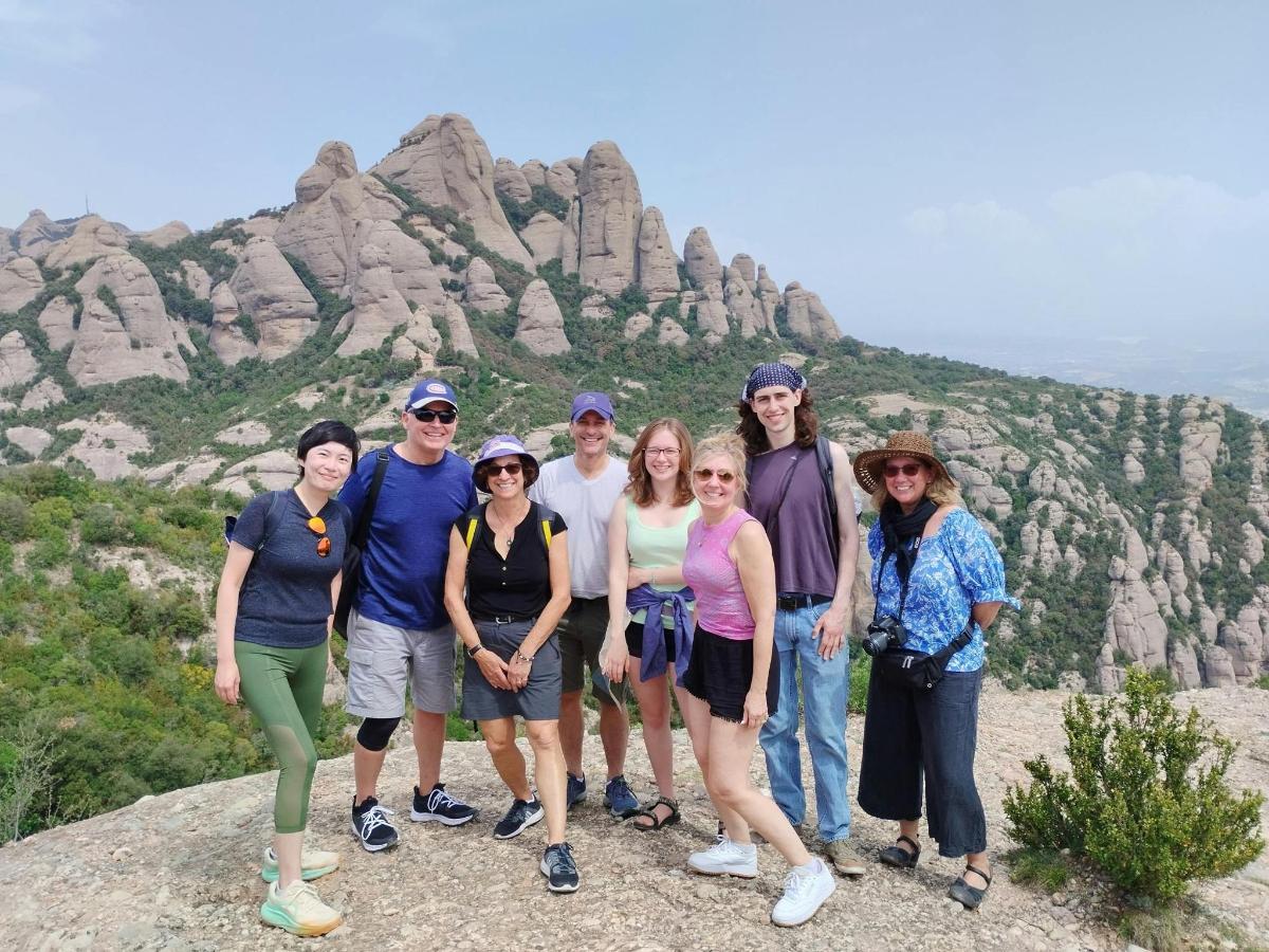 a group of people standing on top of a mountain