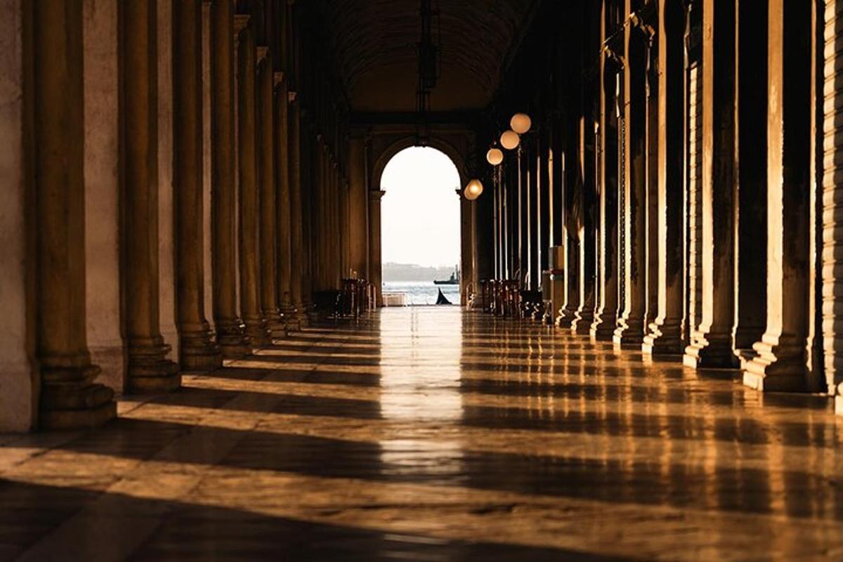 a hallway of a building with columns and an archway
