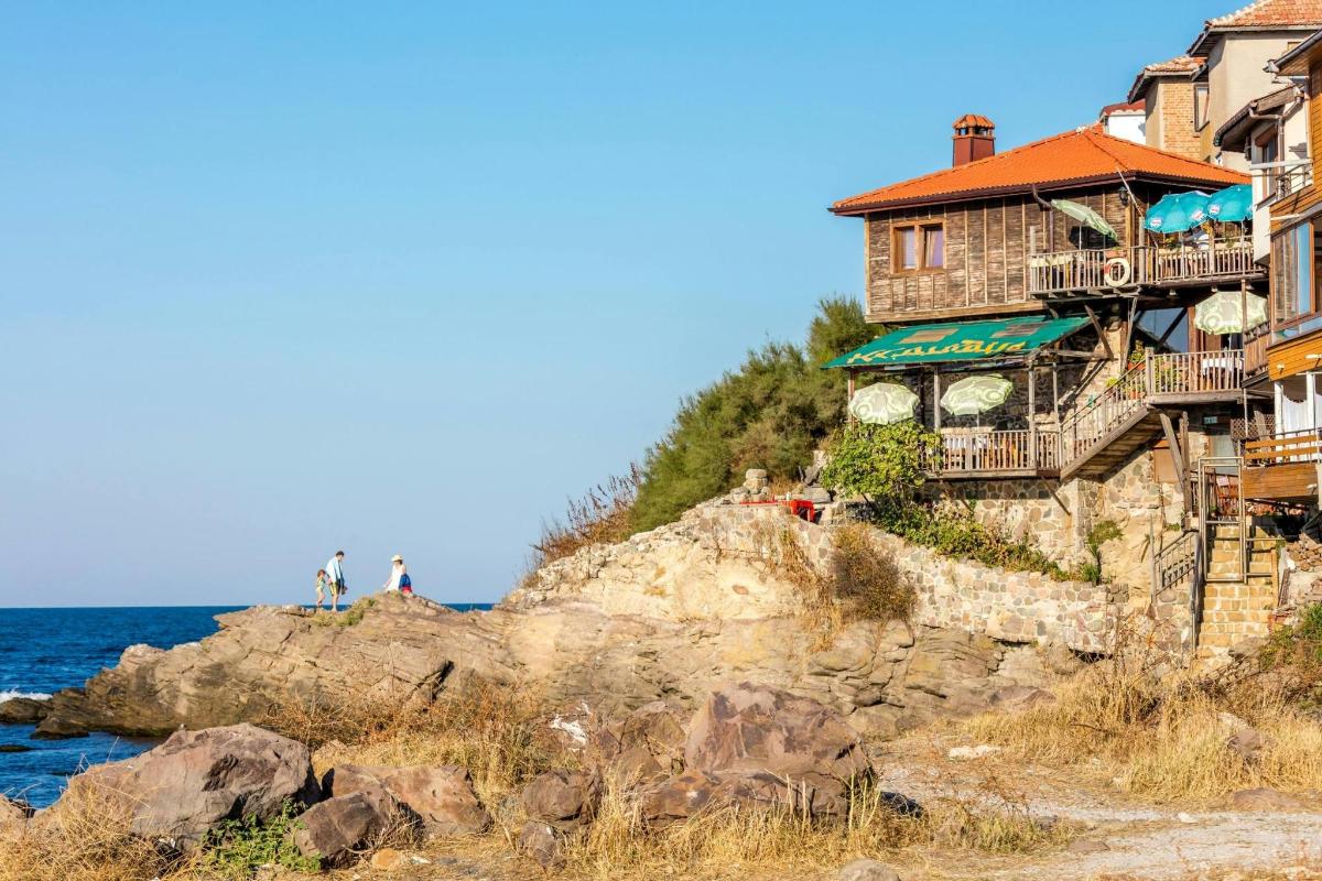 a house on a cliff next to the ocean