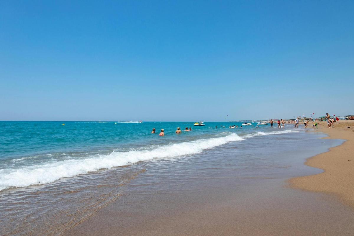 a group of people in the water at the beach