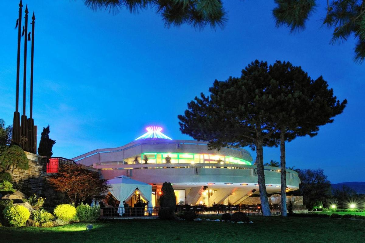 a large building with a lit up roof at night