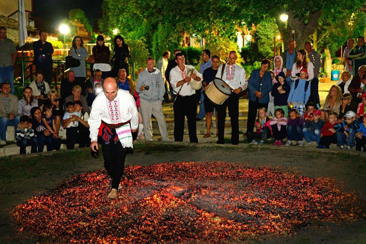 a man is walking through a circle of red confetti