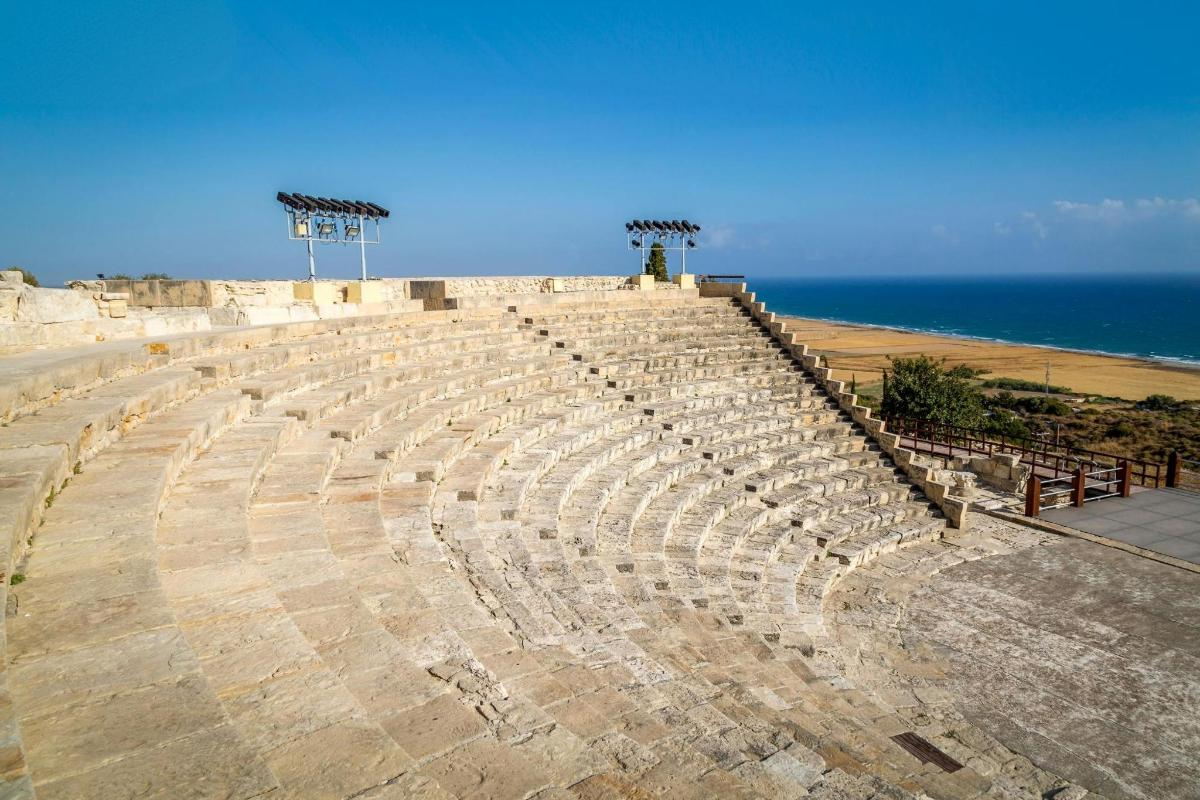 an amphitheater with the ocean in the background
