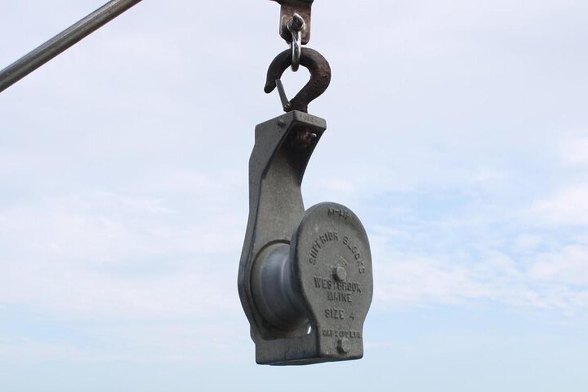 a metal padlock hanging from a pole