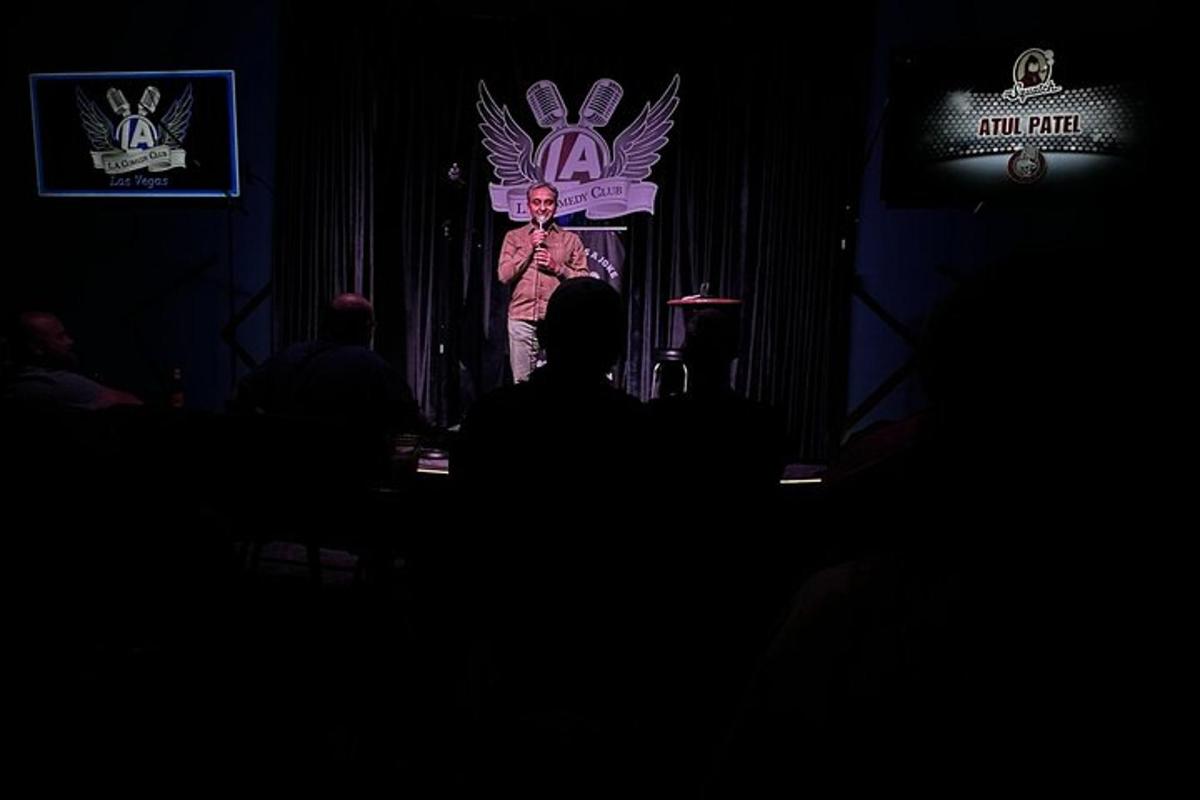 a man standing on a stage in a dark room
