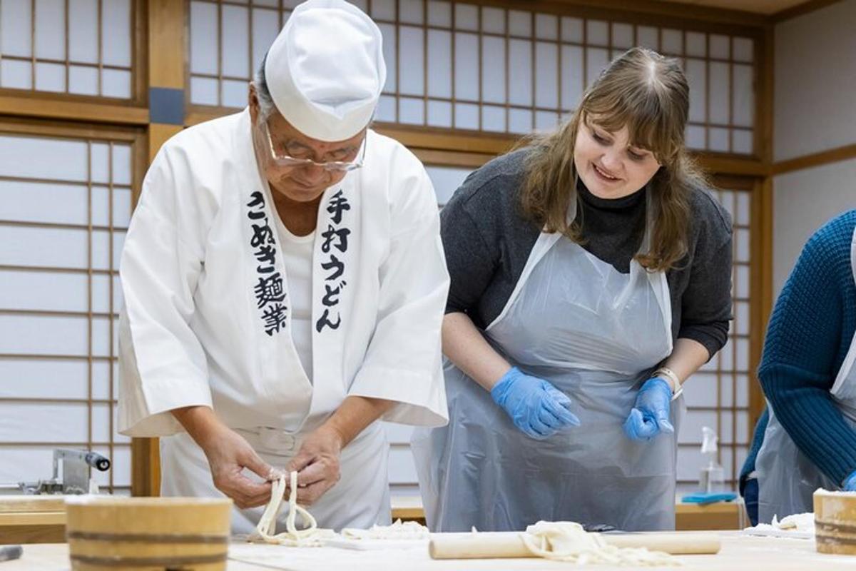 a man and a woman in a kitchen preparing food