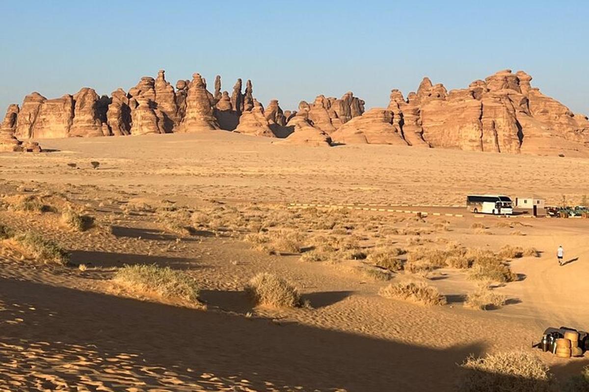 a camper in the desert with rocks in the background