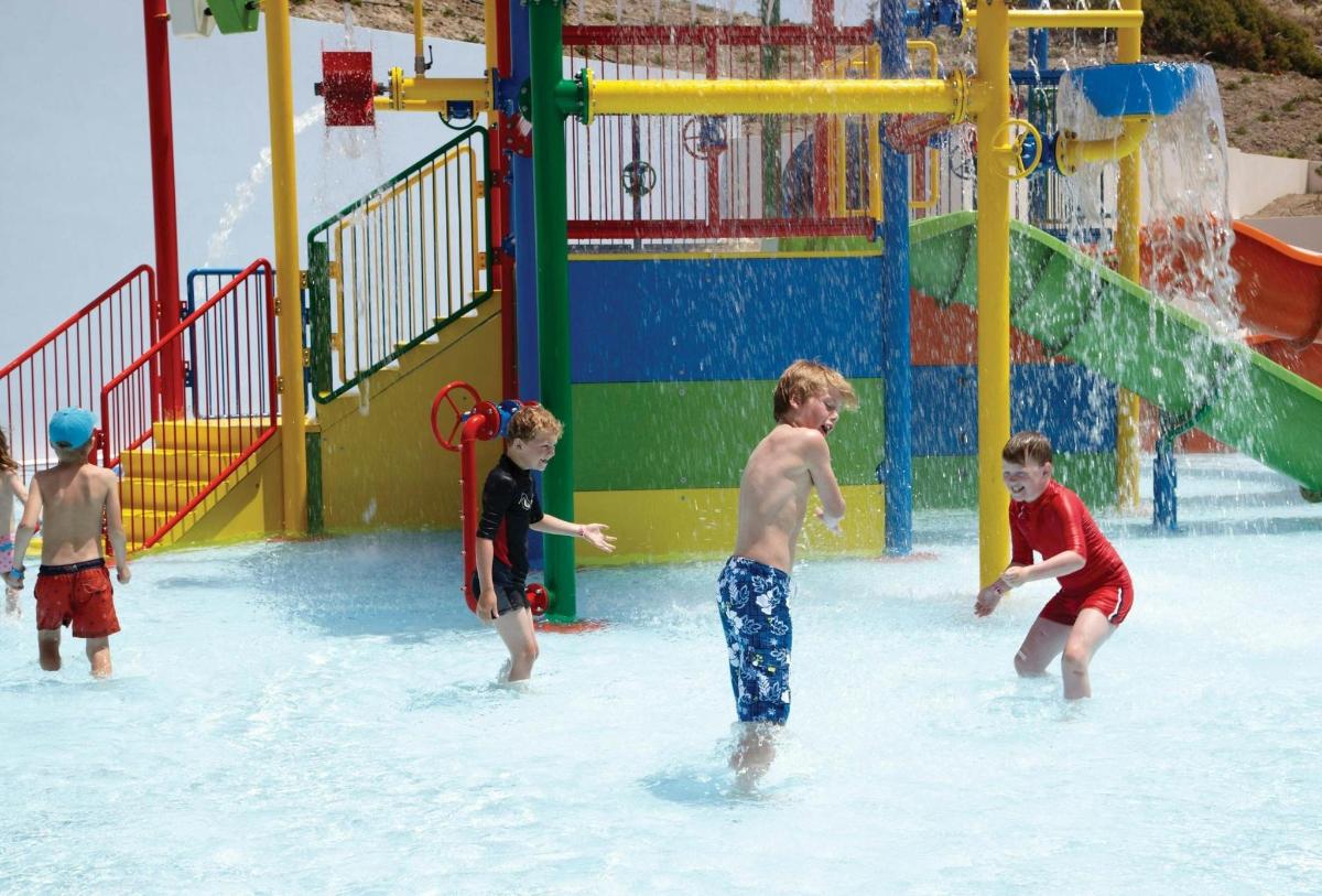 a group of children playing in a water park