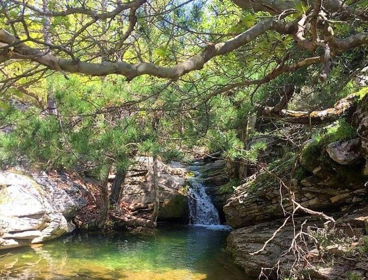 a small waterfall in the middle of a river