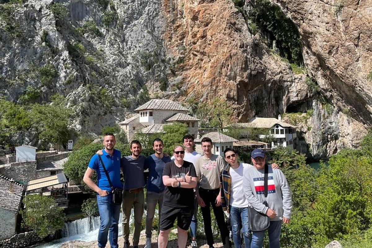 un gruppo di uomini in piedi davanti a una cascata