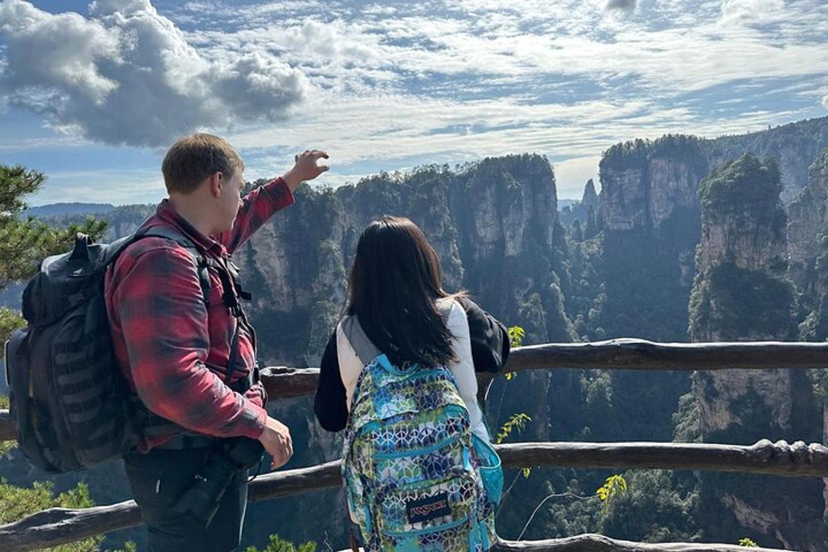 a man and a woman standing on top of a mountain