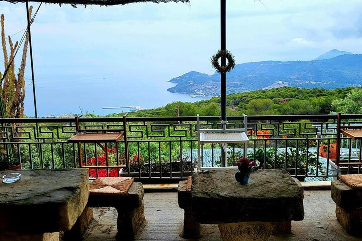 a balcony with tables and a view of a mountain