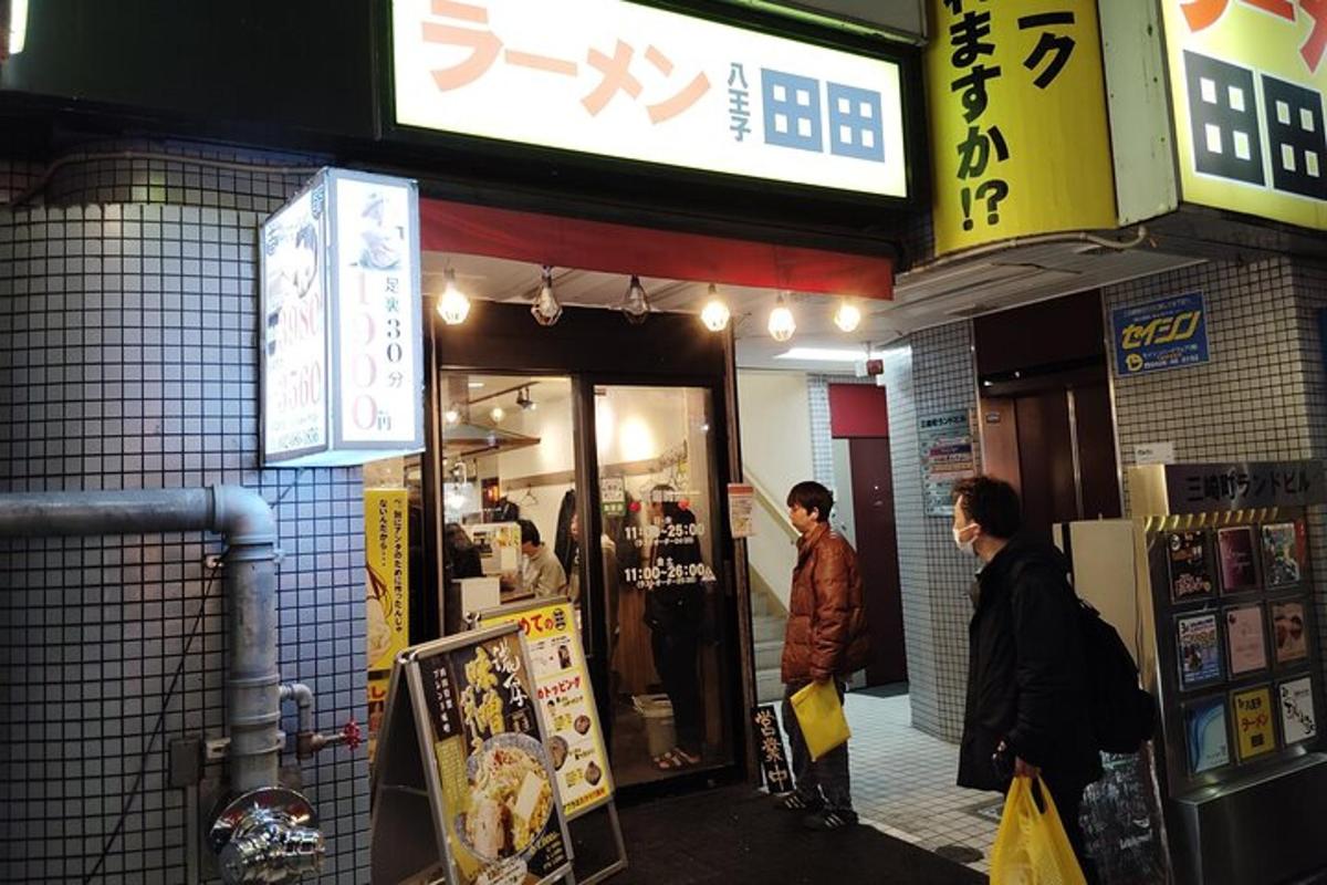 two people standing outside of a store in a street