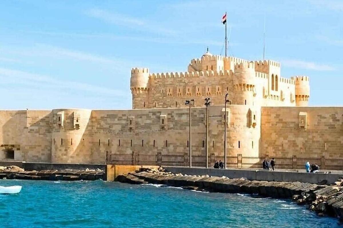 a large castle sitting next to a body of water