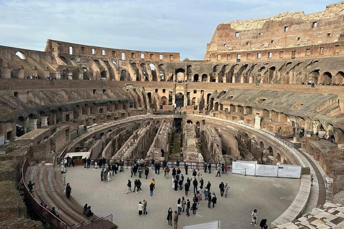 a group of people walking around the coliseum