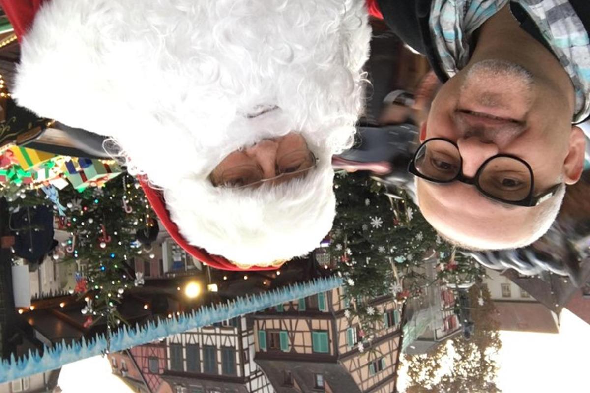 a man wearing glasses and a santa claus mask