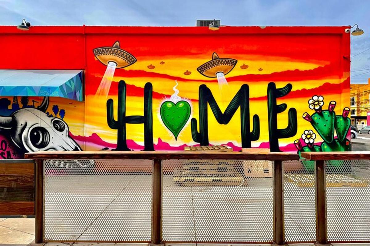 a sign on a building with graffiti on it