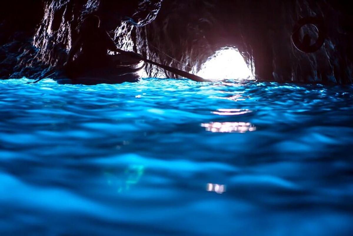 a dark cave with blue water in it