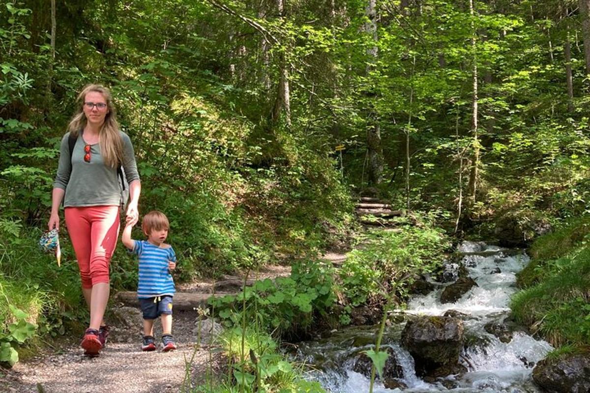 una donna e un bambino camminano lungo un ruscello