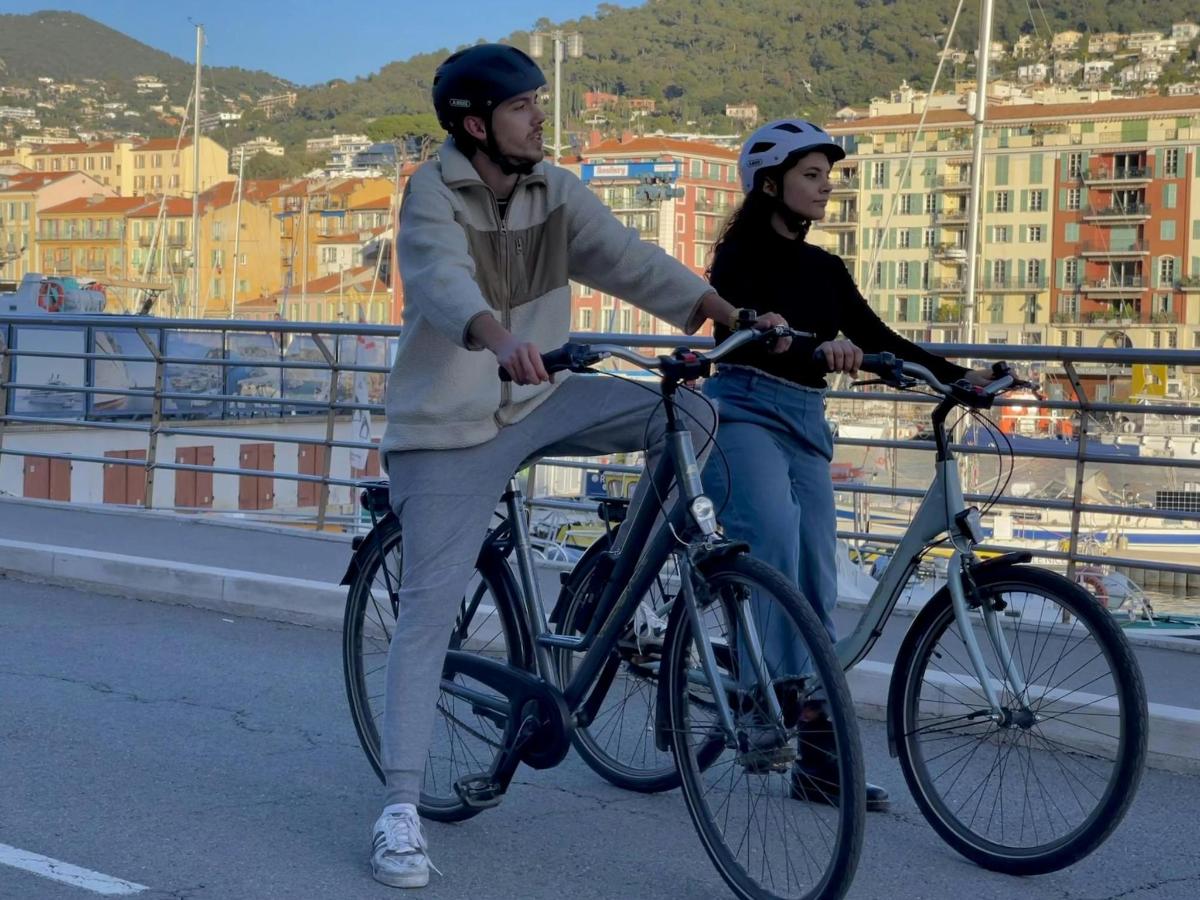 two people riding their bikes on a bridge