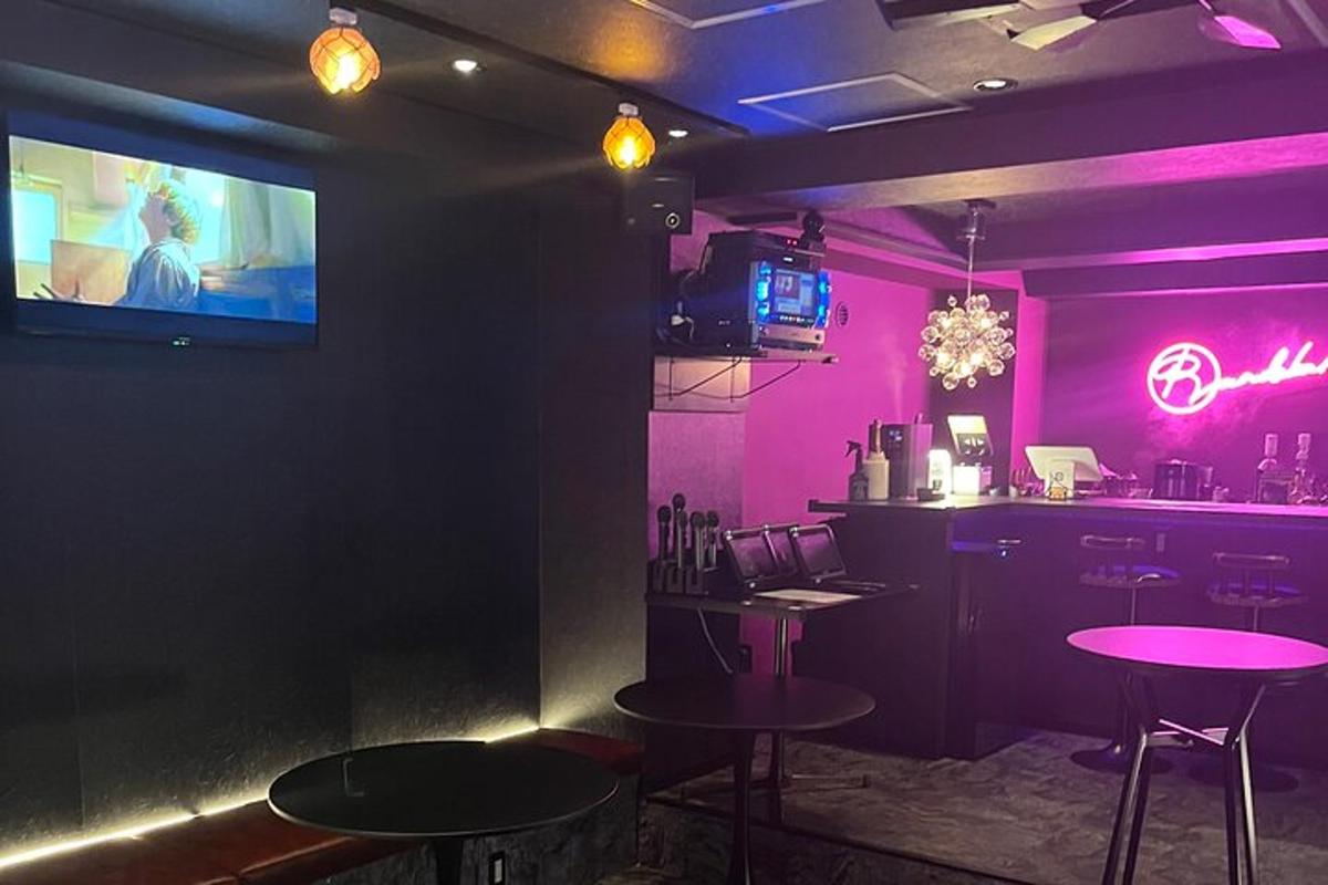 a bar with two tables and a tv on the wall