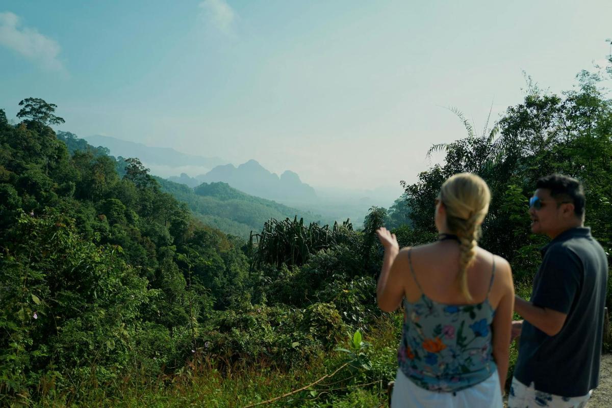 a man and a woman looking out over a valley