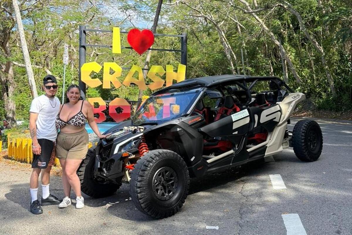 a man and a woman standing next to a black truck