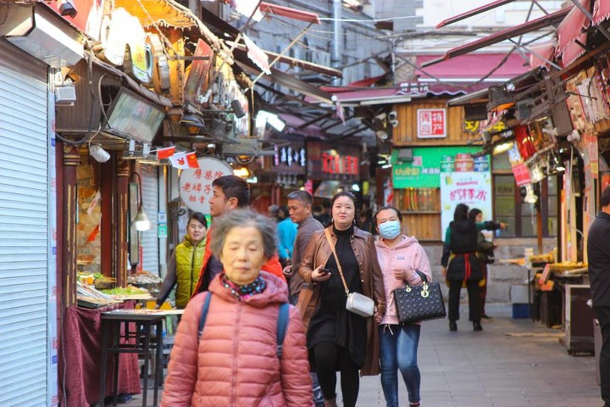 a group of people walking through a market