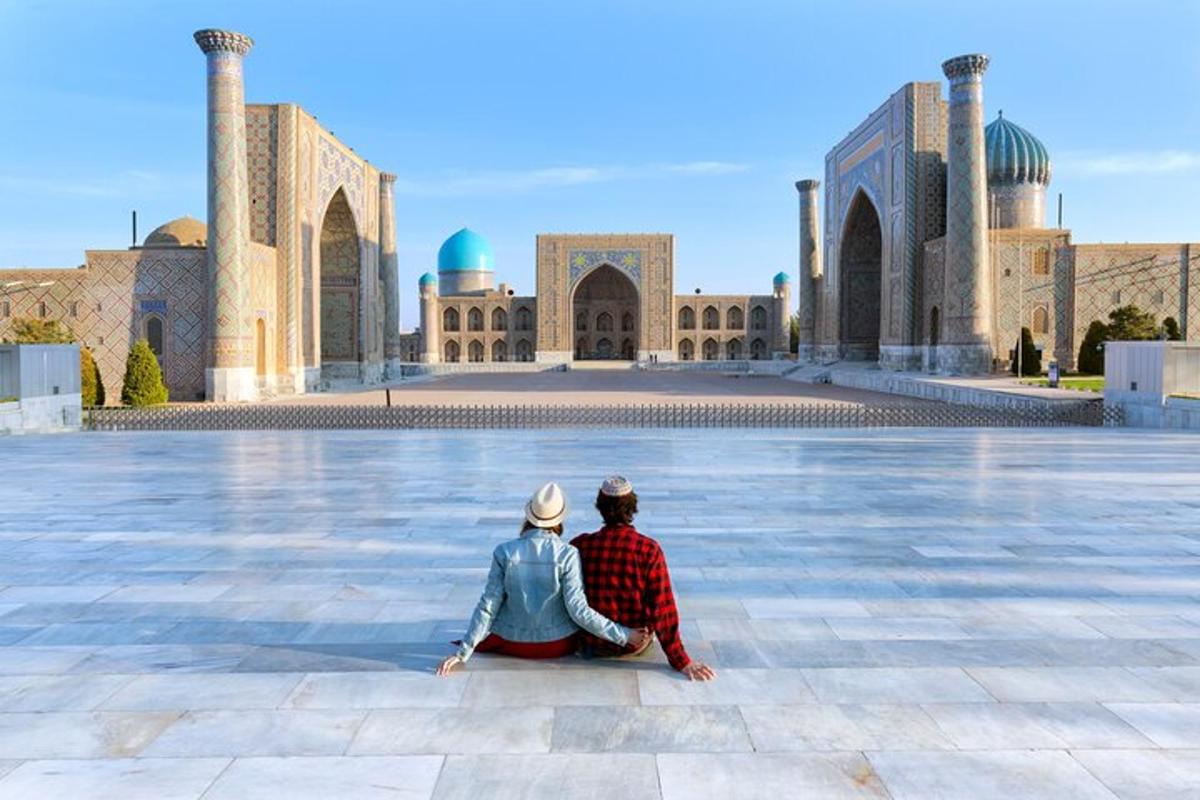 two people sitting in front of a mosque