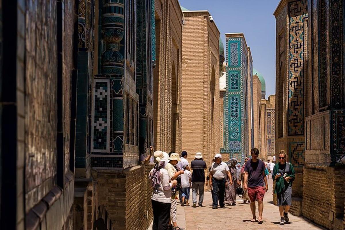 a group of people walking down a street with tall buildings