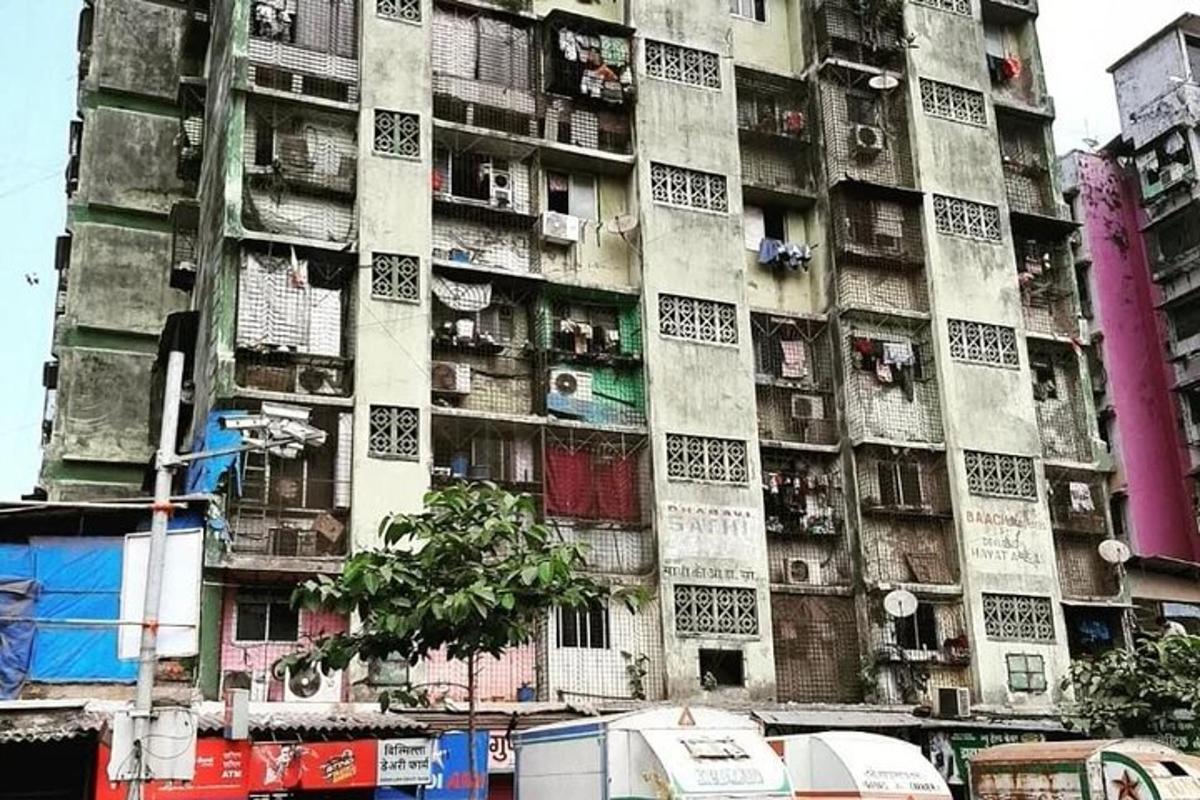 a tall apartment building with people in the windows