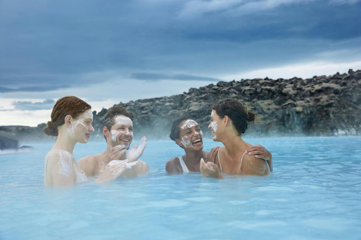 a group of people swimming in the blue lagoon