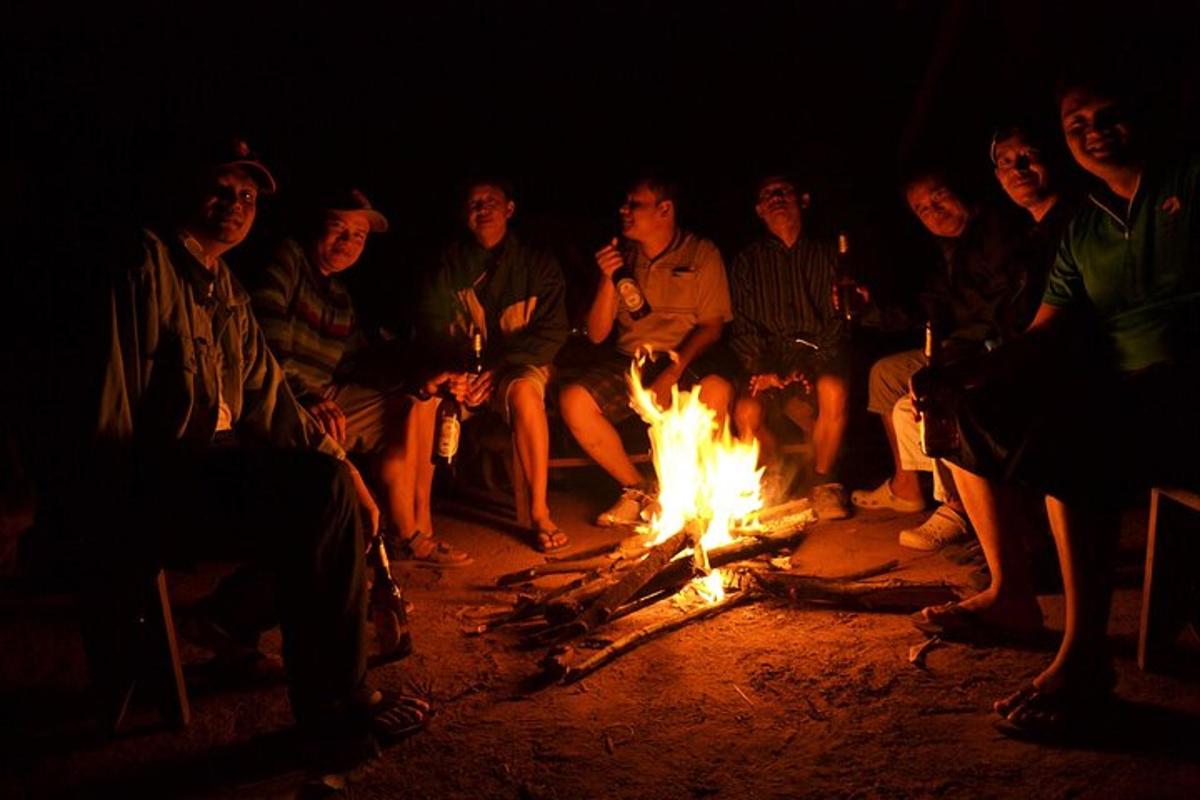 a group of people sitting around a fire