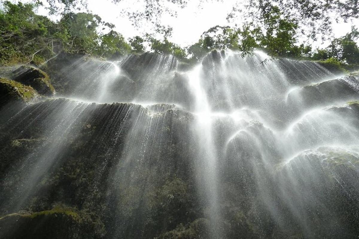 una cascada con el sol brillando sobre ella