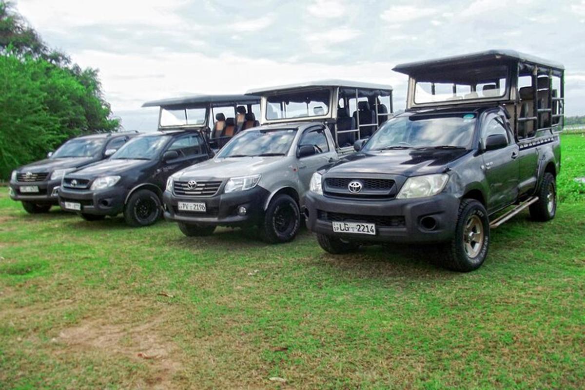 a group of four cars parked in a field