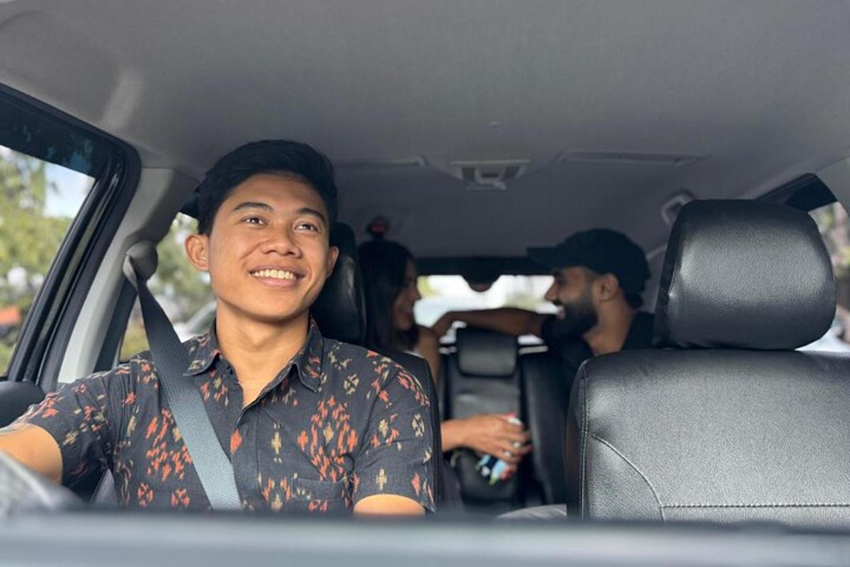 a man sitting in the back seat of a car