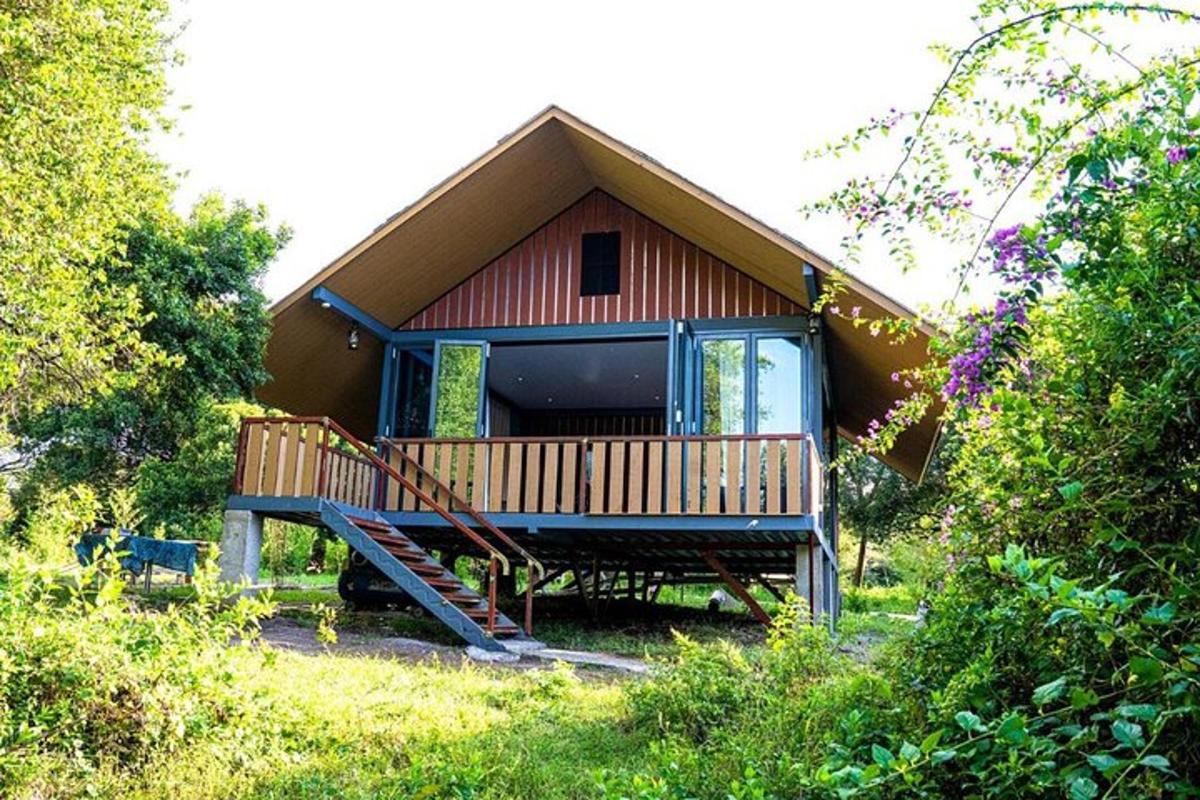a small house with a porch and a staircase to it