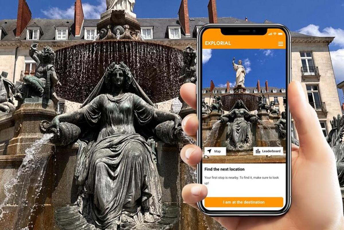 a person holding up a cell phone in front of a fountain